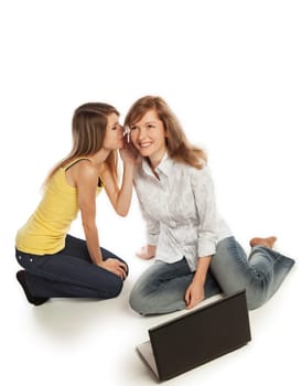 Two pretty blond girls whispering about their secrets  isolated on white background