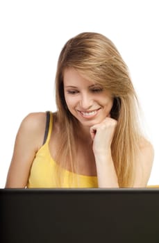 Smiling blond woman looking at computer screen  isolated on white