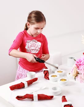 Girl helps to set the table