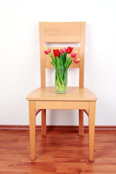 Chair with flowers by the wall