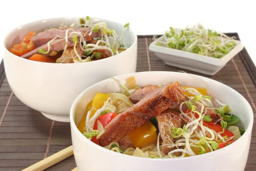 crispy duck breast with fried noodles and vegetables