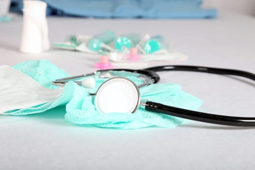 A stethoscope,bandage and syringes from a table at the doctor's