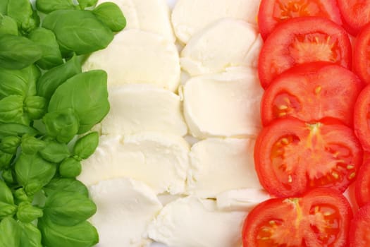 Basil leaves,mozzarella and tomato slices in front of white hint