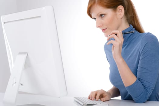 Modern office - young business woman work at computer