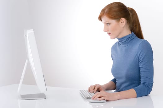 Modern office - young business woman work at computer