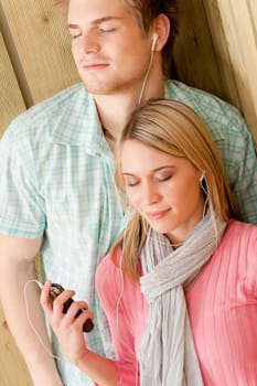 Couple in love - enjoy summer on beach listen to music