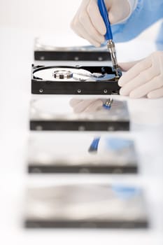 Computer engineer repair hard disc defect, experiment in sterile laboratory