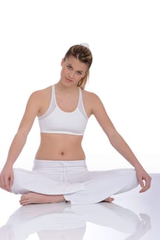 Fitness - Young woman in yoga position on white background relaxing