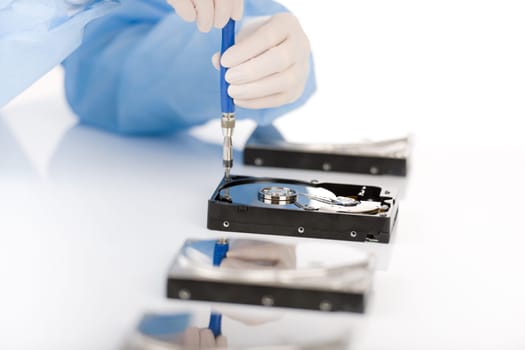 Computer engineer repair hard disc defect, experiment in sterile laboratory