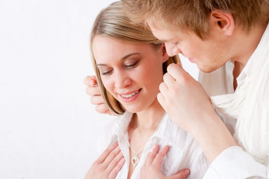 Couple in love - getting present necklace with heart pendant