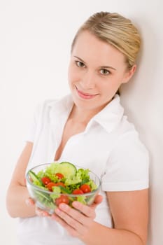 Healthy lifestyle - smiling woman with vegetable salad on white