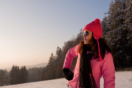 Fashion model with sunglasses watching winter sunset