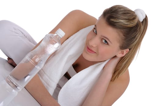 Fitness - Young sportive woman with water and towel on white background