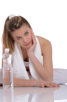 Fitness - Young sportive woman with water and towel on white background
