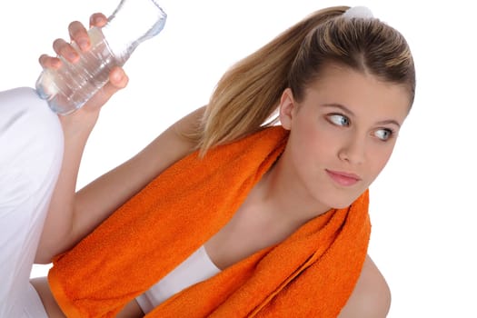 Fitness - Young sportive woman with water and towel on white background