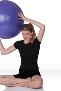 Fitness - Young happy woman with exercise ball on white background