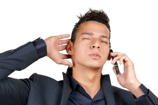 Worried young business man having a conversation on a mobile phone. Isolated on white.