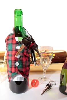 bottle dressed in jacket warmer with keys as arms on white background depicting drunk driving