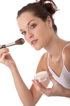 Young woman applying powder on white background