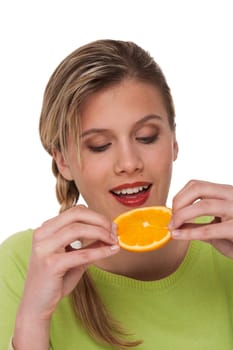Woman biting orange on white background