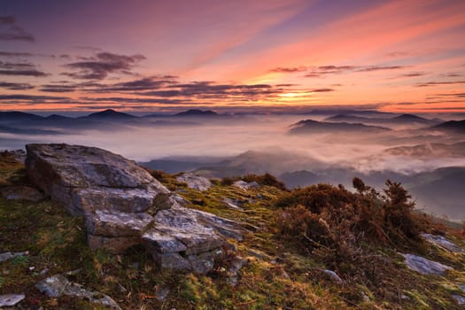 Mountains over the fog in the winter sunrise, Bizkaia, Spain