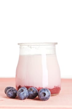 Delicious glass of yogurt and fresh blueberries. Shallow depth of field