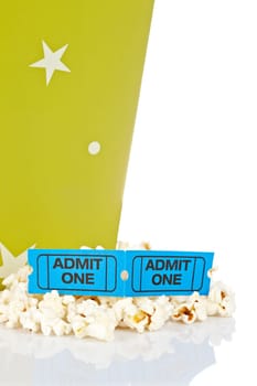 Popcorn bucket with two tickets isolated on a white background. Shallow depth of field