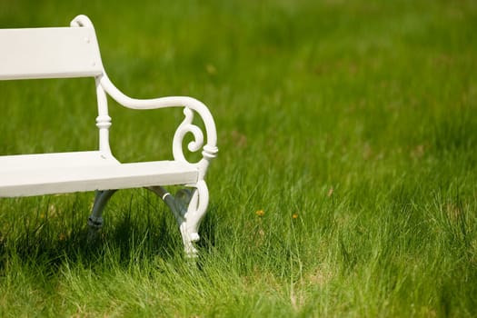 Spring and summer - White romantic bench in meadow on sunny day