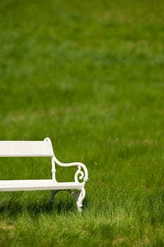 Spring and summer - White romantic bench in meadow on sunny day