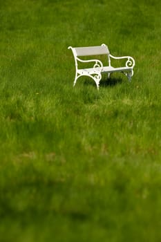 Spring and summer - White romantic bench in meadow on sunny day