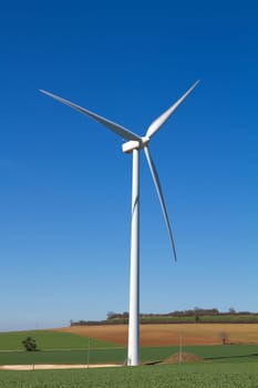 A wind turbine under clear blue sky
