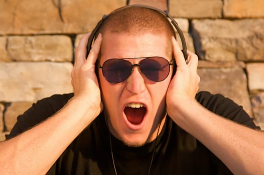 A cool young man listens to music on some headphones