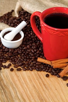 Coffee beans spilling from a burlap sack and fresh coffee
