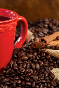 Coffee beans spilling from a burlap sack and fresh coffee