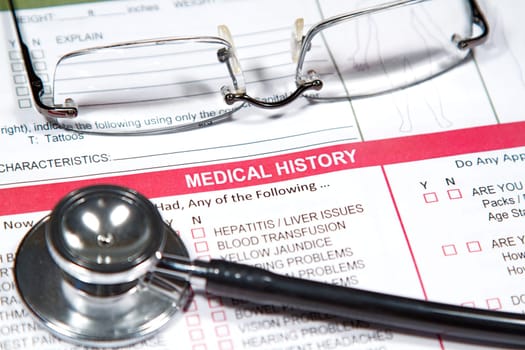 Close up of a Medical History form and a doctor&#039 s Stethoscope