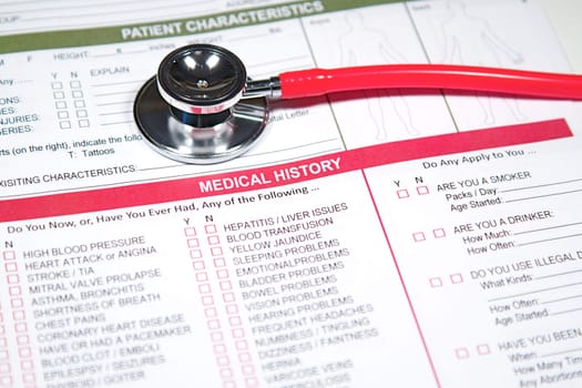 Close up of a Medical History form and a doctor&#039 s Stethoscope