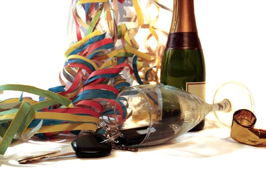champagne with keys inside fallen glass on white background depicting drunk driving and addictions can kill