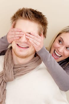 Couple in love - woman cover eyes of man having fun