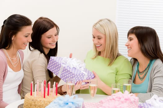 Birthday party - happy woman getting present, champagne, cake