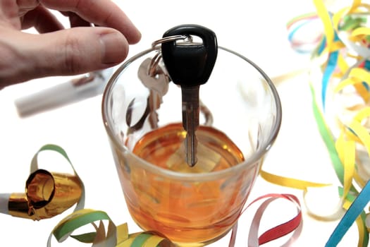 hand about to take car keys with whiskey glass on white background depicting drunk driving and addictions can kill