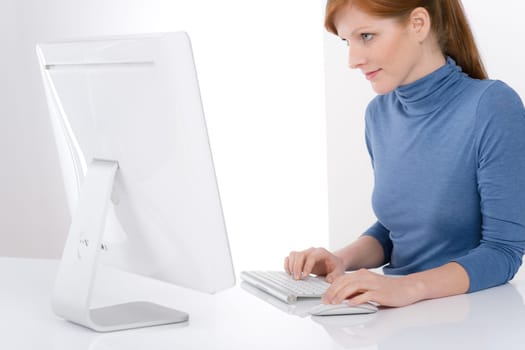 Modern office - young business woman work at computer