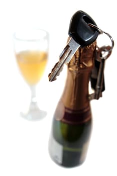 champagne bottle with keys hanging on bottle with glass on white background depicting drunk driving and addictions can kill