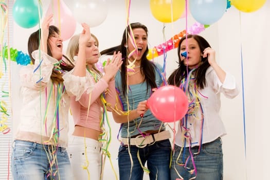 Birthday party celebration - four woman with confetti have fun, toast, dance