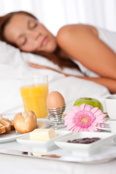 Young woman having breakfast in luxury hotel room