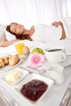 Young woman having breakfast in luxury hotel room