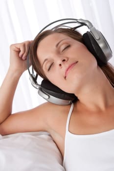 Woman with closed eyes enjoying music with headphones