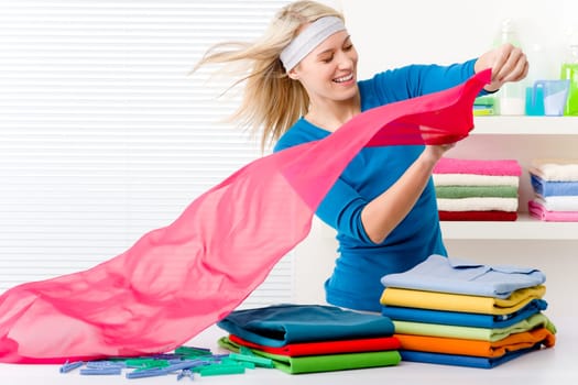 Laundry - woman folding clothes, housework
