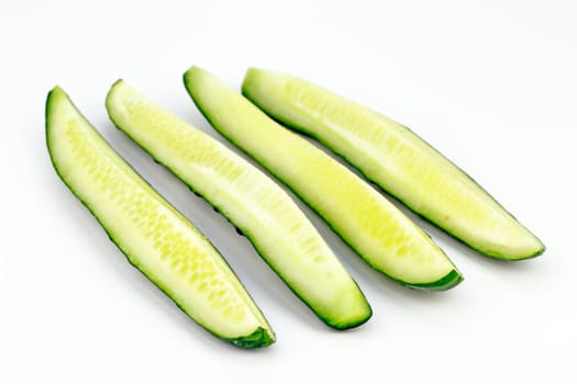 One organic green vegetable sliced in quarters lengthwise.