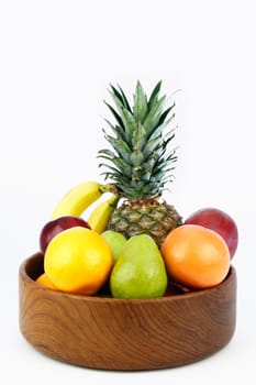 Teak wood bowl holds a mix of tropical and other juicy whole food.