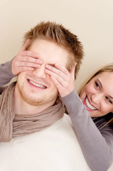 Couple in love - woman cover eyes of man having fun